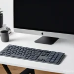 최고의 무선 키보드와 마우스 세트 - **"A modern, minimalist home office desk bathed in soft, natural light, showcasing a sleek, dark gre...